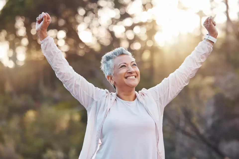 Older woman stretching and smiling